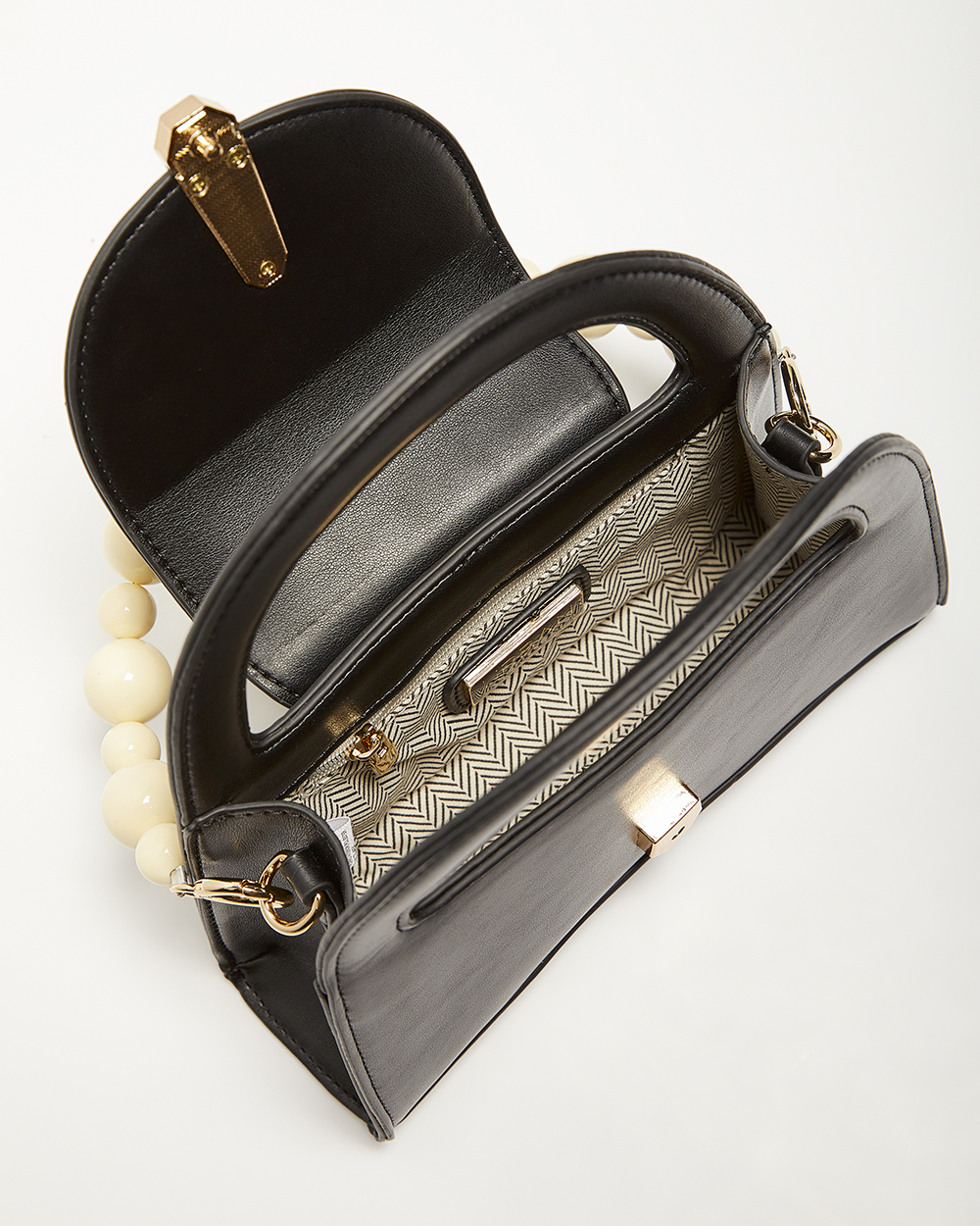 Black structured handbag with gold hardware shot open from above