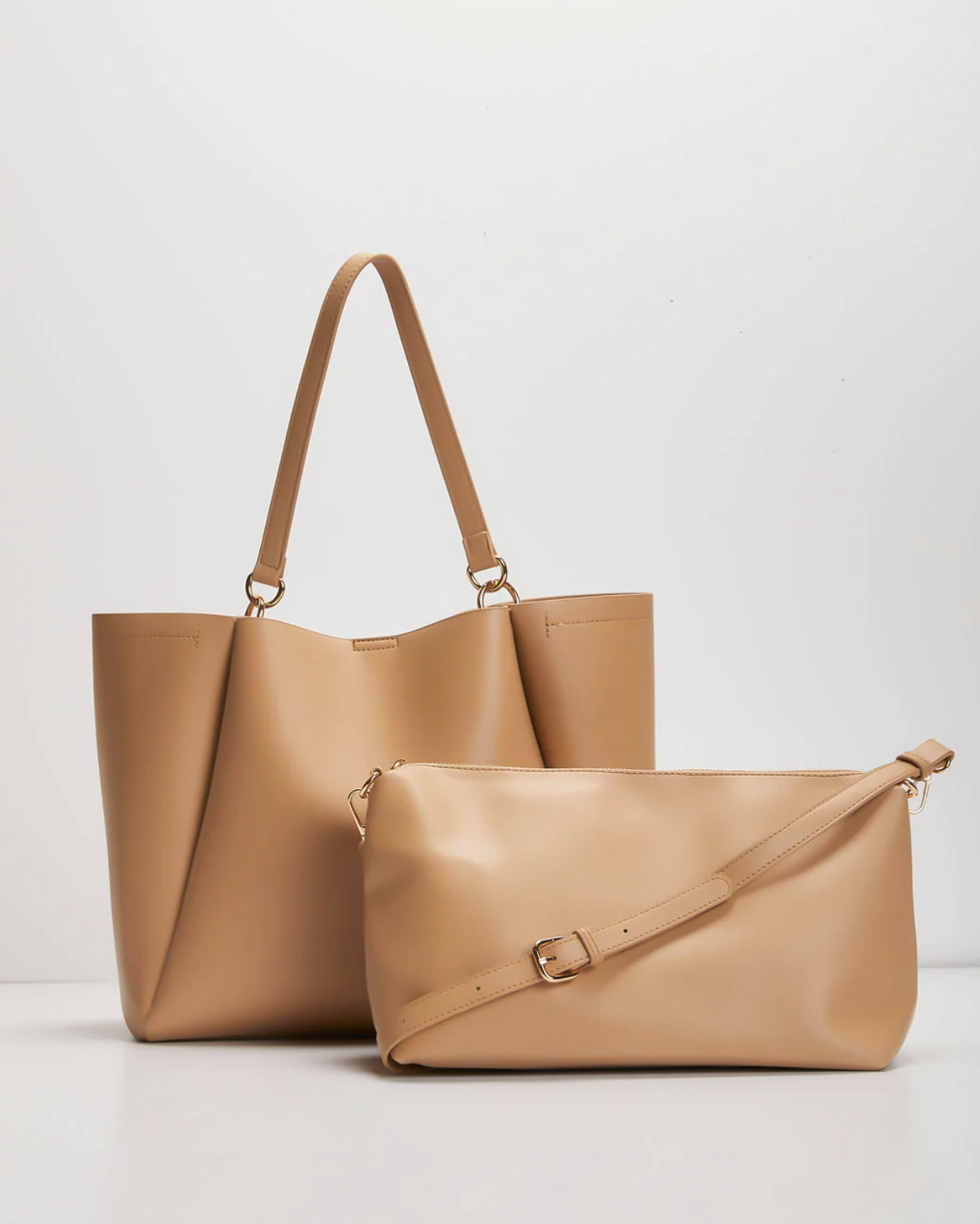 Neutral leather tote and shoulder bag on white backdrop